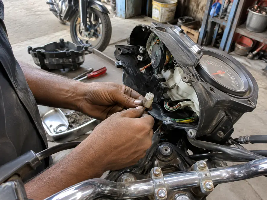 Bike meter diagnosis by mechanic at Dinesh Bike Point